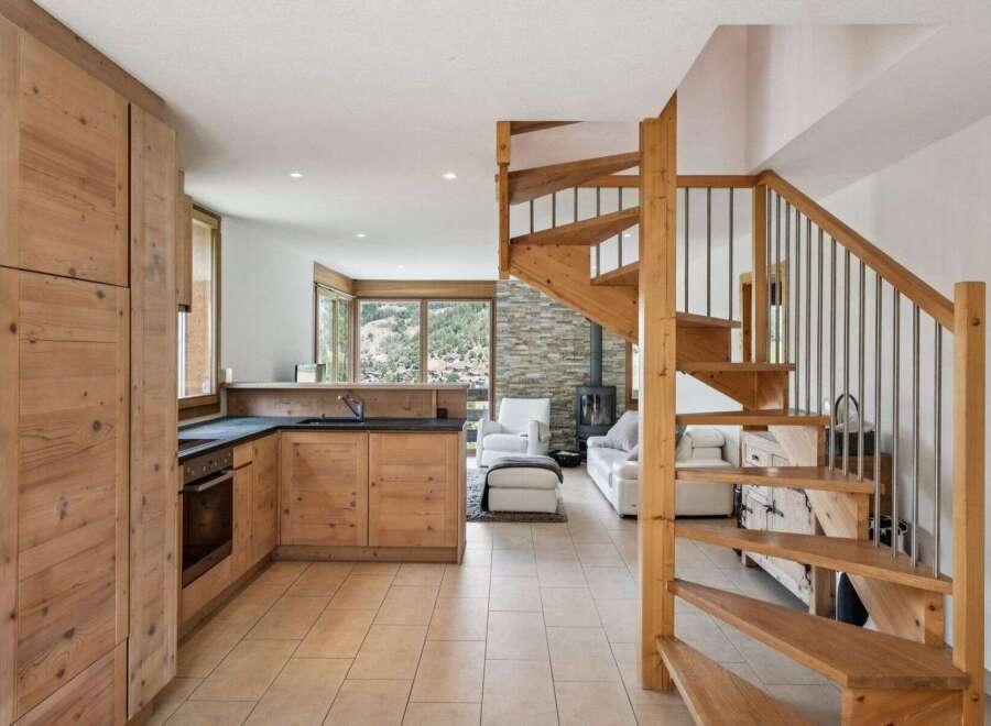 Discover the charm of this stunning property featuring a beautifully designed kitchen with wooden cabinetry and modern appliances.
