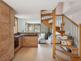 Discover the charm of this stunning property featuring a beautifully designed kitchen with wooden cabinetry and modern appliances.