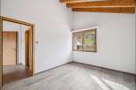 Discover this bright and airy room, featuring a modern design with light-colored wooden floors and pristine white walls.
