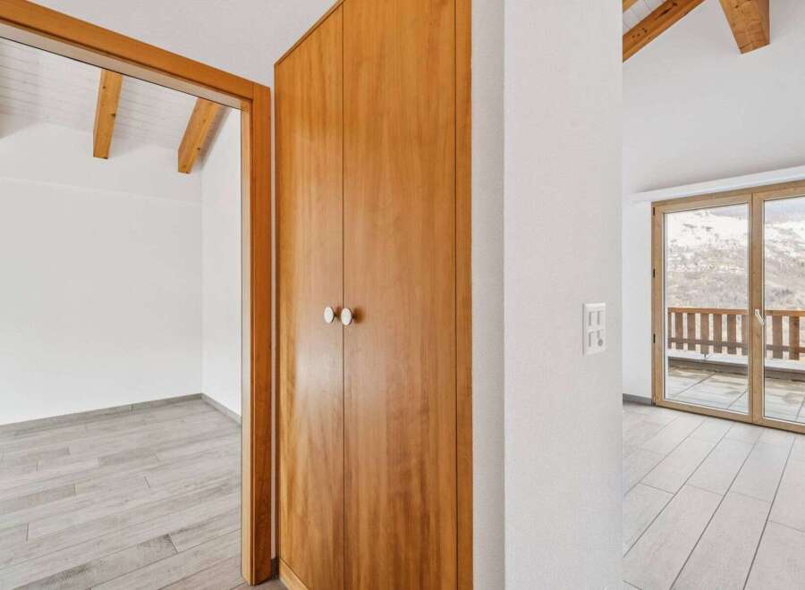 Discover the charm of this inviting property, featuring a beautifully crafted wooden wardrobe and a bright, airy interior.