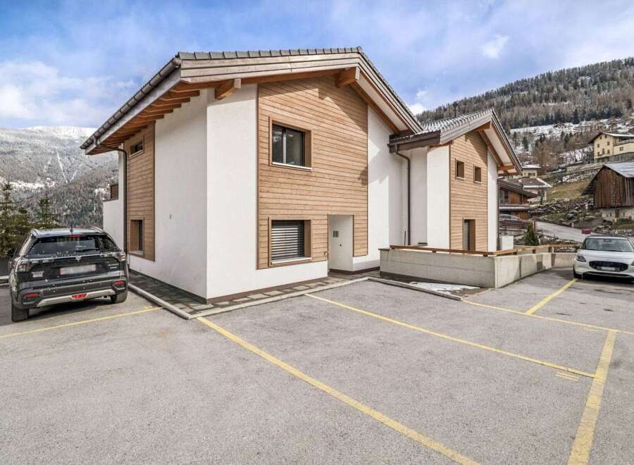 Discover this stunning property featuring a modern design with a blend of wood and white exterior.