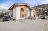 Discover this stunning property featuring a modern design with a blend of wood and white exterior.