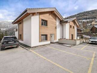 Discover this stunning property featuring a modern design with a blend of wood and white exterior.