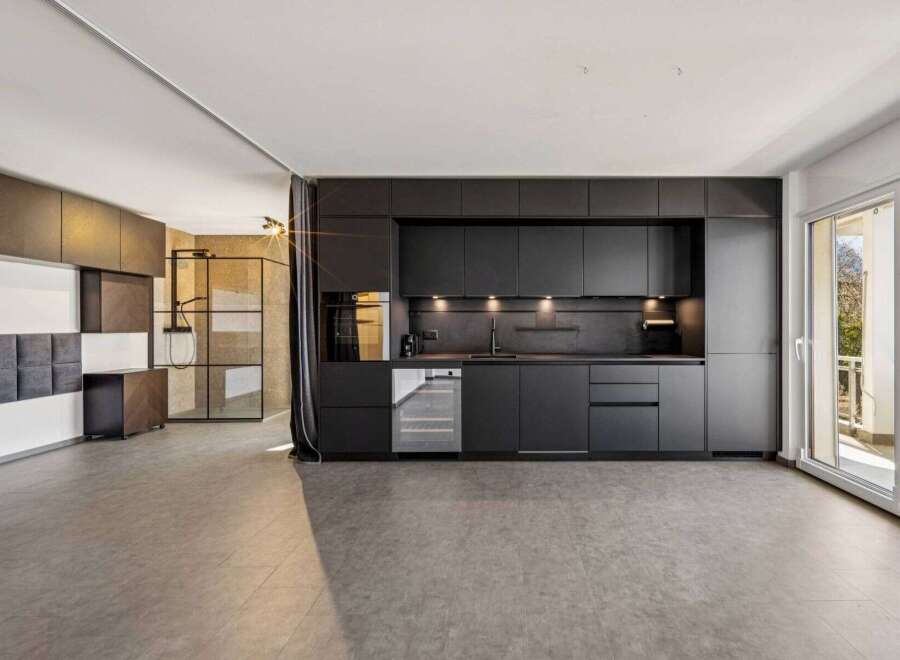 This modern kitchen boasts sleek black cabinetry, offering a sophisticated and contemporary design.