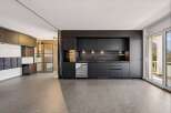 This modern kitchen boasts sleek black cabinetry, offering a sophisticated and contemporary design.