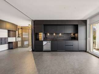 This modern kitchen boasts sleek black cabinetry, offering a sophisticated and contemporary design.