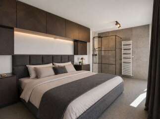 Experience luxury in this modern bedroom featuring a sleek design and high-end finishes.