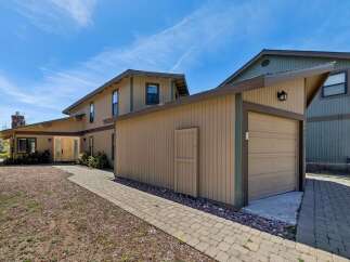 This stunning property boasts a beautiful exterior with a charming garage and a welcoming pathway.