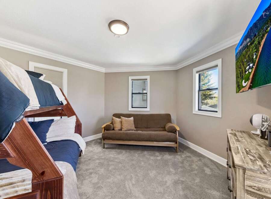 This cozy bedroom features a bunk bed, perfect for accommodating guests or family.