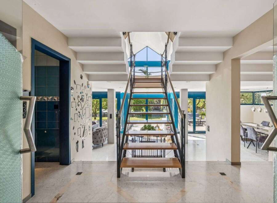 Step into luxury with this stunning property featuring a grand staircase as its centerpiece.