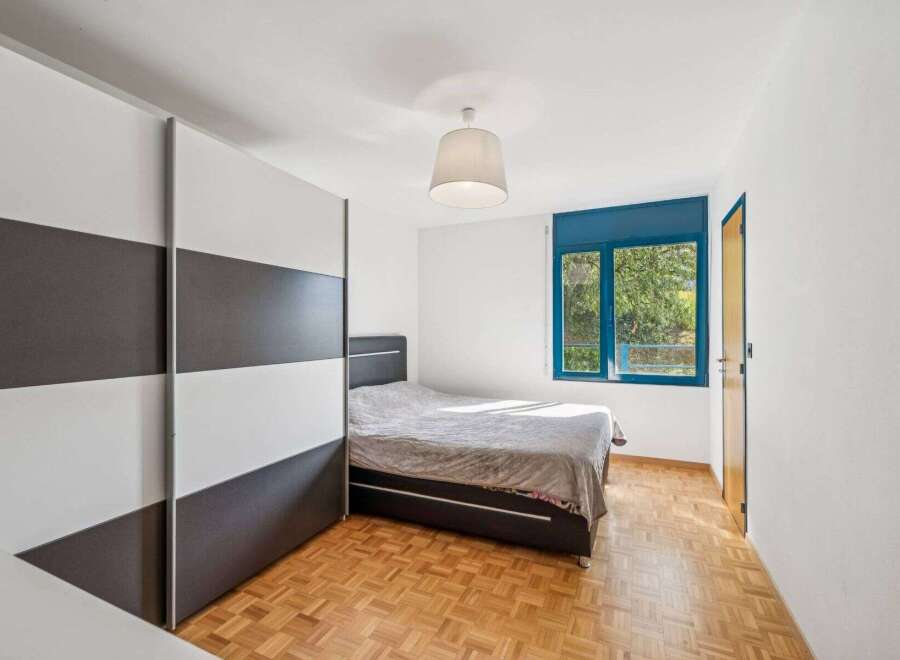 Discover this inviting bedroom featuring a modern design and ample natural light.