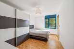 Discover this inviting bedroom featuring a modern design and ample natural light.
