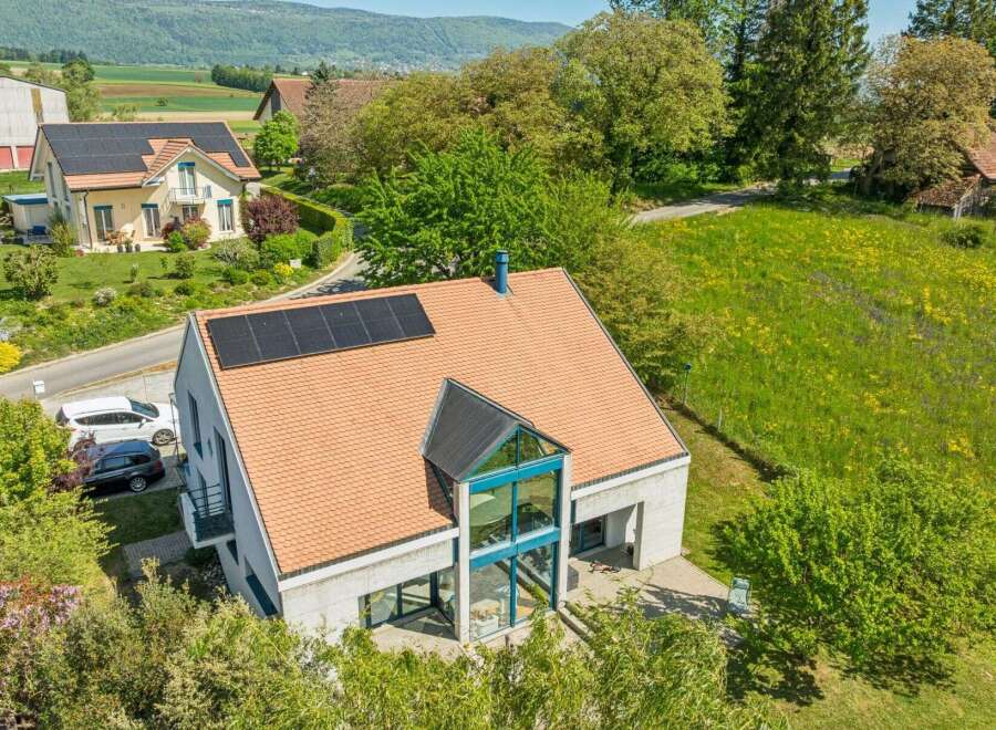 Discover this stunning modern home featuring solar panels and a unique architectural design.