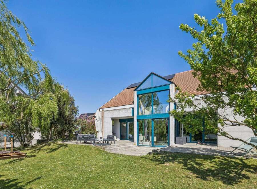 Discover this stunning property featuring a modern architectural design and expansive glass windows that flood the interior with natural light.