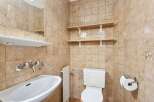 This charming bathroom features a classic design with tiled walls and a functional layout.