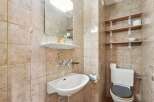 This charming bathroom features a classic design with tiled walls and a functional layout.