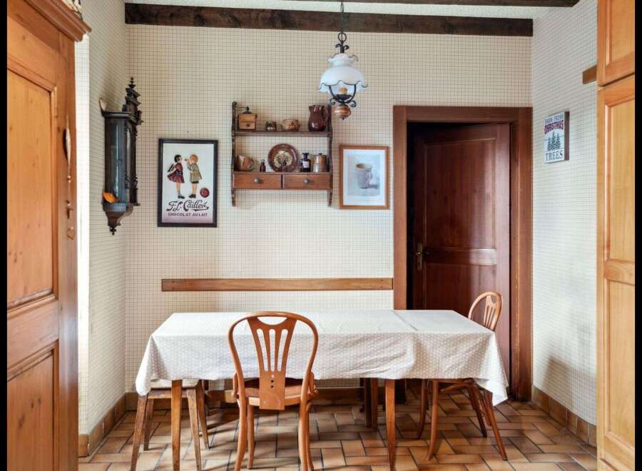This charming dining area features a rustic wooden table and chairs, perfect for intimate meals.
