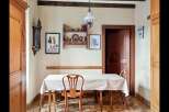 This charming dining area features a rustic wooden table and chairs, perfect for intimate meals.