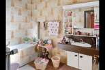 This charming bathroom features a classic design with tiled walls and a cozy atmosphere.