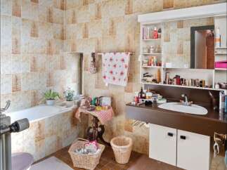 This charming bathroom features a classic design with tiled walls and a cozy atmosphere.