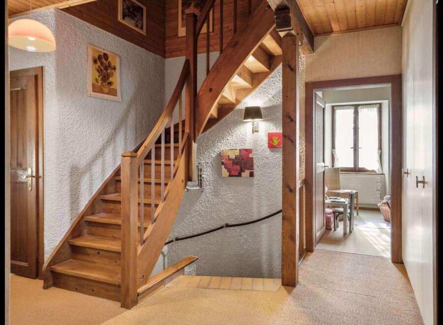 This charming property features a beautifully crafted wooden staircase, adding warmth and character to the interior.