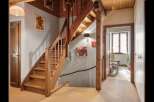 This charming property features a beautifully crafted wooden staircase, adding warmth and character to the interior.