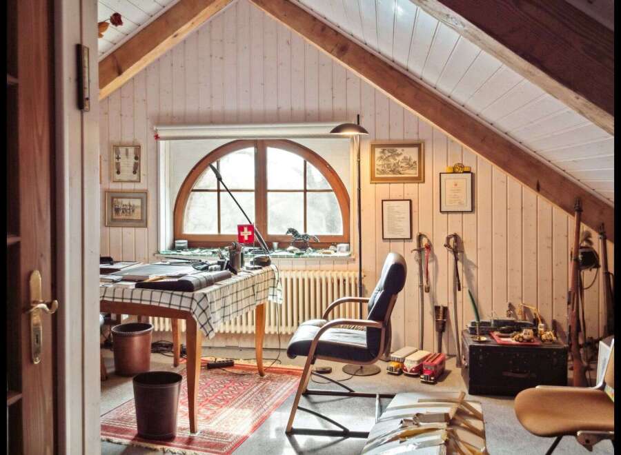 Step into a charming attic office space, perfect for creative pursuits or focused work.