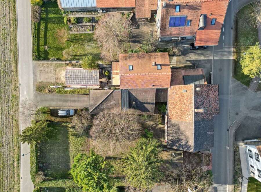 Discover this charming property, featuring a well-maintained house with a classic red-tiled roof.