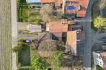 Discover this charming property, featuring a well-maintained house with a classic red-tiled roof.