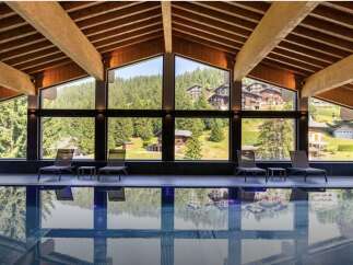 This luxurious indoor pool offers stunning views of the surrounding mountains and forests.