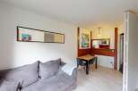 Discover this cozy apartment featuring a comfortable gray sofa, perfect for relaxing.