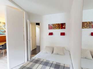 Discover this cozy bedroom featuring a comfortable bed, perfect for relaxation.