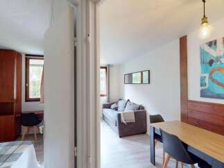 Discover this cozy apartment featuring a comfortable living area and a well-equipped dining space.