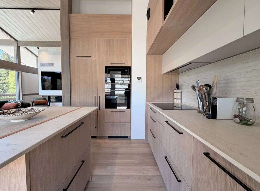 This stunning kitchen boasts a modern design with sleek cabinetry and a spacious layout, perfect for culinary enthusiasts.
