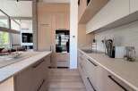This stunning kitchen boasts a modern design with sleek cabinetry and a spacious layout, perfect for culinary enthusiasts.