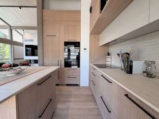 This stunning kitchen boasts a modern design with sleek cabinetry and a spacious layout, perfect for culinary enthusiasts.