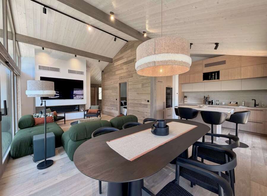 Experience luxury living in this stunning property, featuring a modern kitchen with sleek cabinetry and a spacious dining area perfect for entertaining.