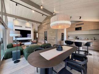 Experience luxury living in this stunning property, featuring a modern kitchen with sleek cabinetry and a spacious dining area perfect for entertaining.