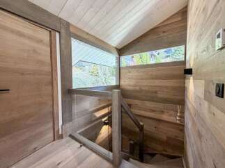 This stunning property boasts a modern interior with a focus on natural materials.