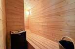 Step into your own private oasis with this stunning sauna! Featuring beautiful wood paneling and a comfortable bench, this space is perfect for relaxation and rejuvenation.