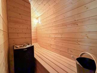 Step into your own private oasis with this stunning sauna! Featuring beautiful wood paneling and a comfortable bench, this space is perfect for relaxation and rejuvenation.