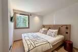 This cozy bedroom features a modern design with a comfortable bed and stylish bedding.