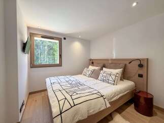 This cozy bedroom features a modern design with a comfortable bed and stylish bedding.