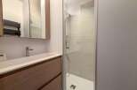 Discover a modern bathroom design featuring a sleek shower enclosure and a stylish vanity.