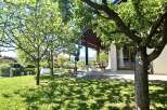 Discover this charming property featuring a lush green lawn and mature trees, creating a serene outdoor space.
