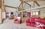 This stunning property boasts a unique architectural design with exposed wooden beams and a spacious layout.