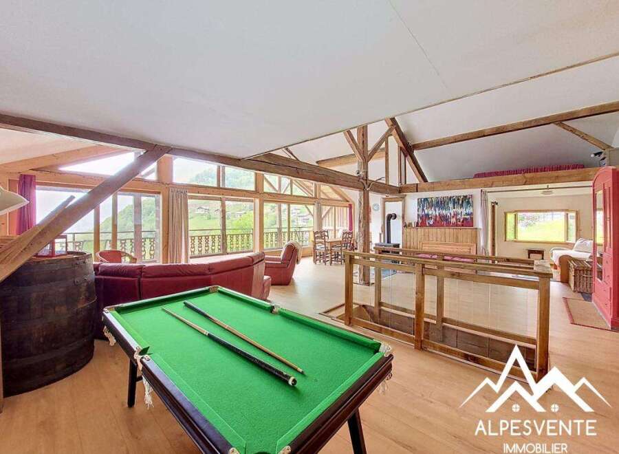 Experience luxury living in this stunning property featuring a spacious interior with a pool table, perfect for entertainment.