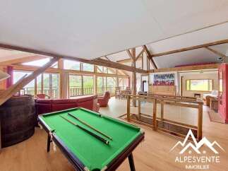 Experience luxury living in this stunning property featuring a spacious interior with a pool table, perfect for entertainment.