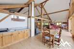 This stunning property boasts a spacious open-plan living area with exposed wooden beams, creating a warm and inviting atmosphere.