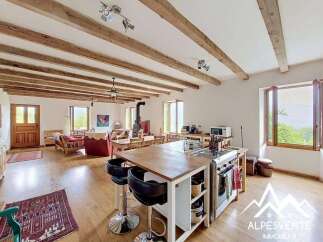 Discover the charm of this stunning property, featuring a spacious open-plan living area with exposed wooden beams and a modern kitchen island.
